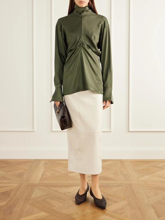 Image of a model wearing Tops. Product name - Slouch Draped Satin Blouse in Dark green colour by brand - TOTEME