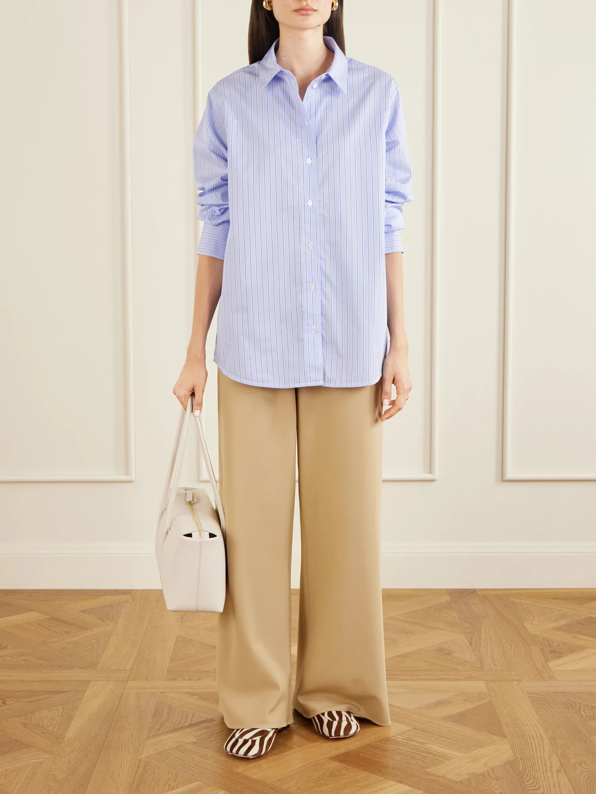 Image of a model wearing Tops. Product name - Essie Striped Cotton-poplin Shirt in Blue colour by brand - Anine Bing