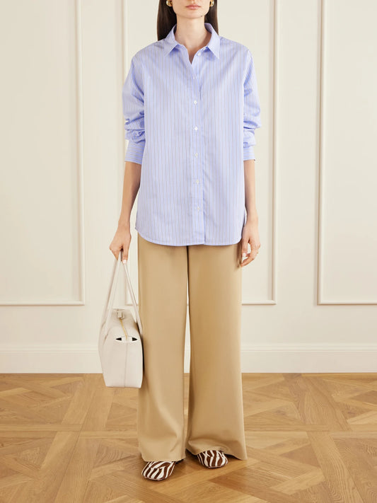 Image of a model wearing Tops. Product name - Essie Striped Cotton-poplin Shirt in Blue colour by brand - Anine Bing