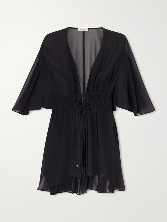 Image of a model wearing Tops. Product name - Midnight Operette Shirred Muslin Blouse in Black colour by brand - Eres