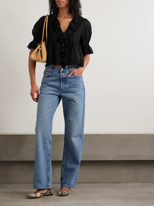Image of a model wearing Tops. Product name - Henri Cropped Ruffled Pintucked Broderie Anglaise Cotton Top in Black colour by brand - DÔEN