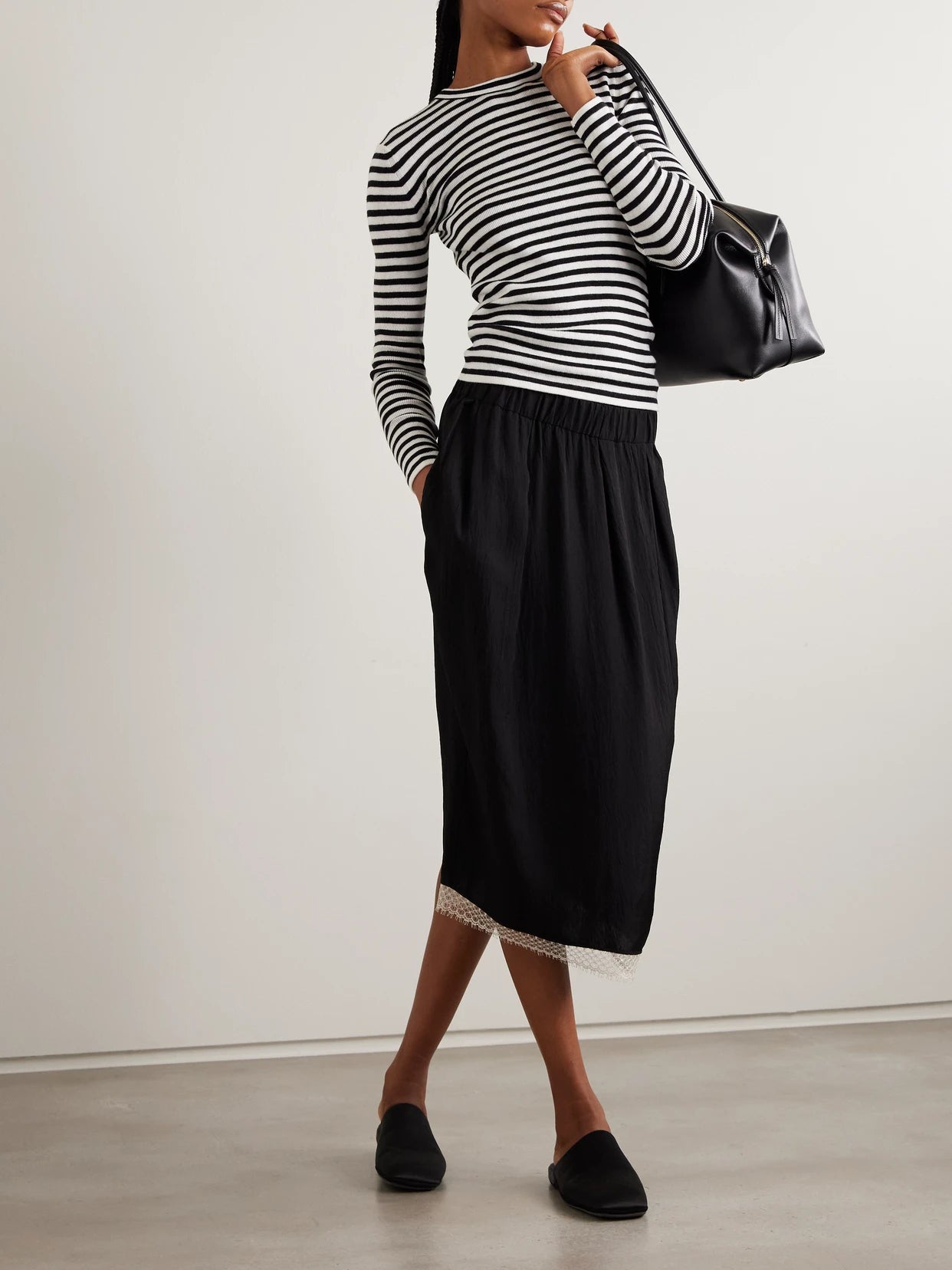 Image of a model wearing Outerwear. Product name - Vivian Striped Ribbed Cotton And Cashmere-blend Top in Black colour by brand - LISA YANG