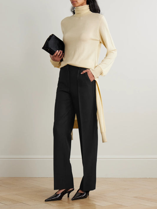 Image of a model wearing Pants. Product name - Recycled Grain De Poudre Straight-leg Pants in Black colour by brand - TOTEME