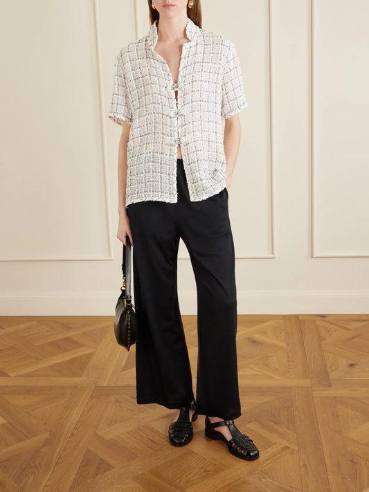 Image of a model wearing Pants. Product name - Cotton And Silk-blend Wide-leg Pants in Black colour by brand - TOTEME
