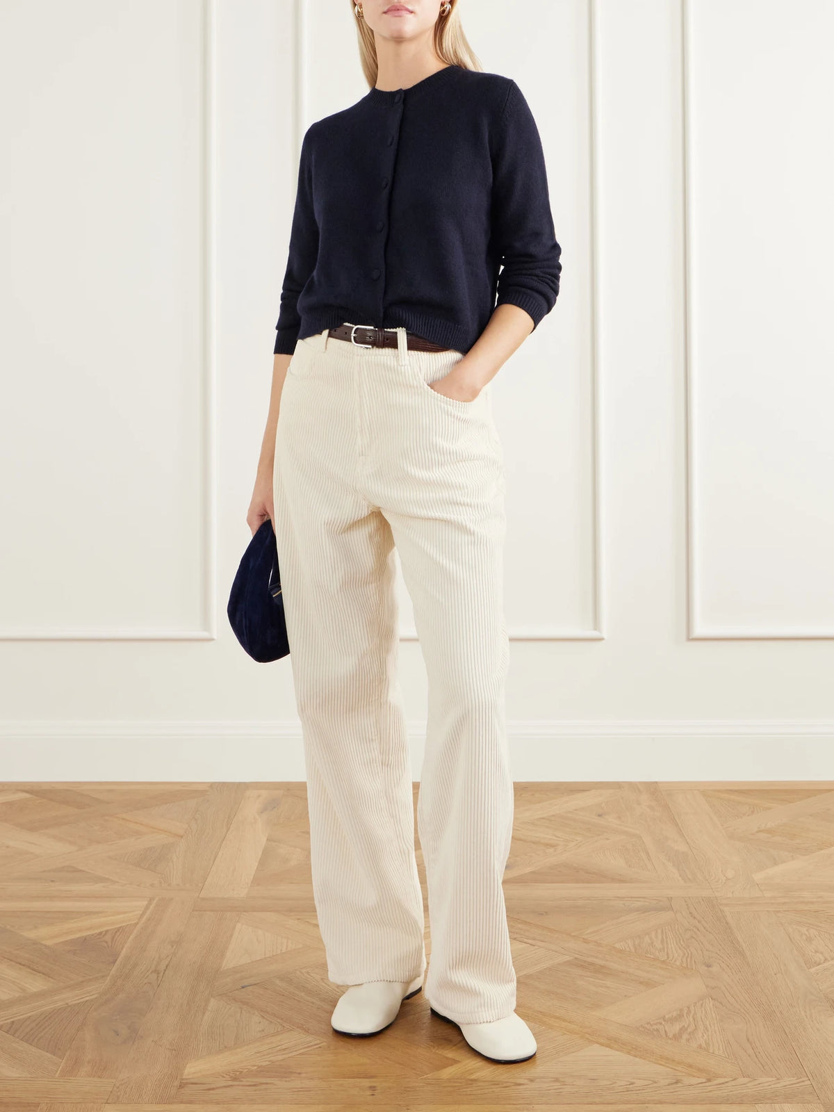 Image of a model wearing Outerwear. Product name - Cropped Cashmere Cardigan in Navy colour by brand - Allude