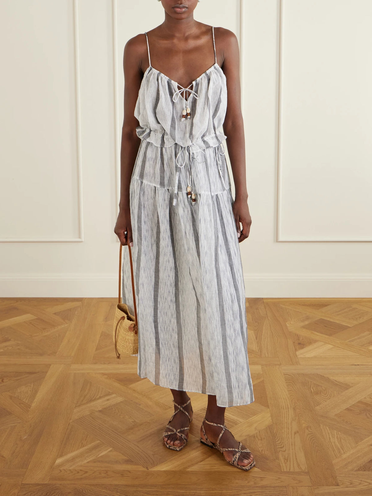 Image of a model wearing Skirts. Product name - Almia Striped Cotton Coverup in Blue colour by brand - Ulla Johnson