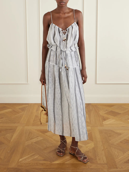 Image of a model wearing Skirts. Product name - Almia Striped Cotton Coverup in Blue colour by brand - Ulla Johnson