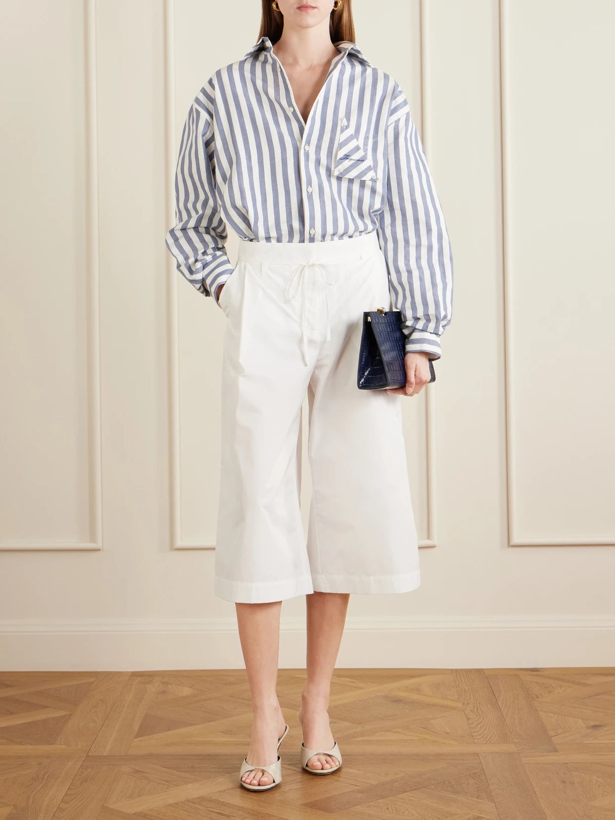 Image of a model wearing Tops. Product name - La Chemise Voilier Striped Cotton-poplin Shirt in Blue colour by brand - Jacquemus