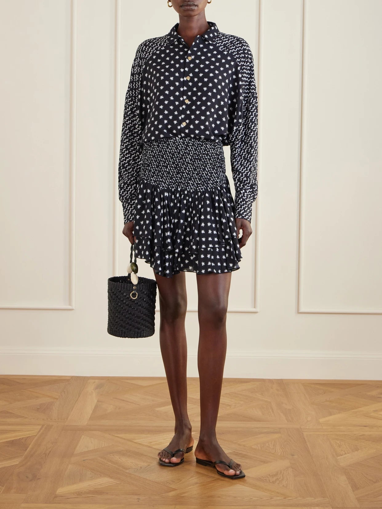 Image of a model wearing Tops. Product name - Estrellitas Y Olas Printed Satin Shirt in Black colour by brand - Donde Esteban