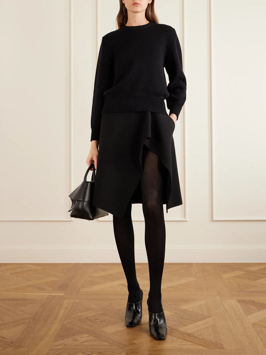 Image of a model wearing Skirts. Product name - Crepe Midi Skirt in Black colour by brand - TOTEME