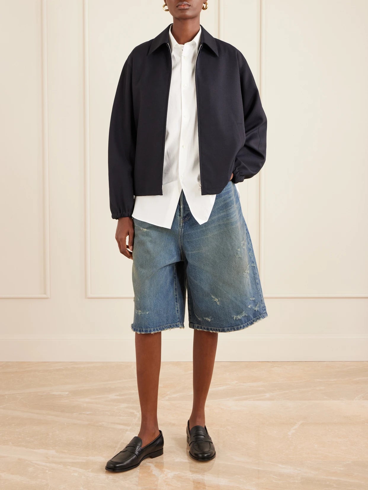 Image of a model wearing Shorts. Product name - Distressed Denim Shorts in Mid denim colour by brand - ssstein