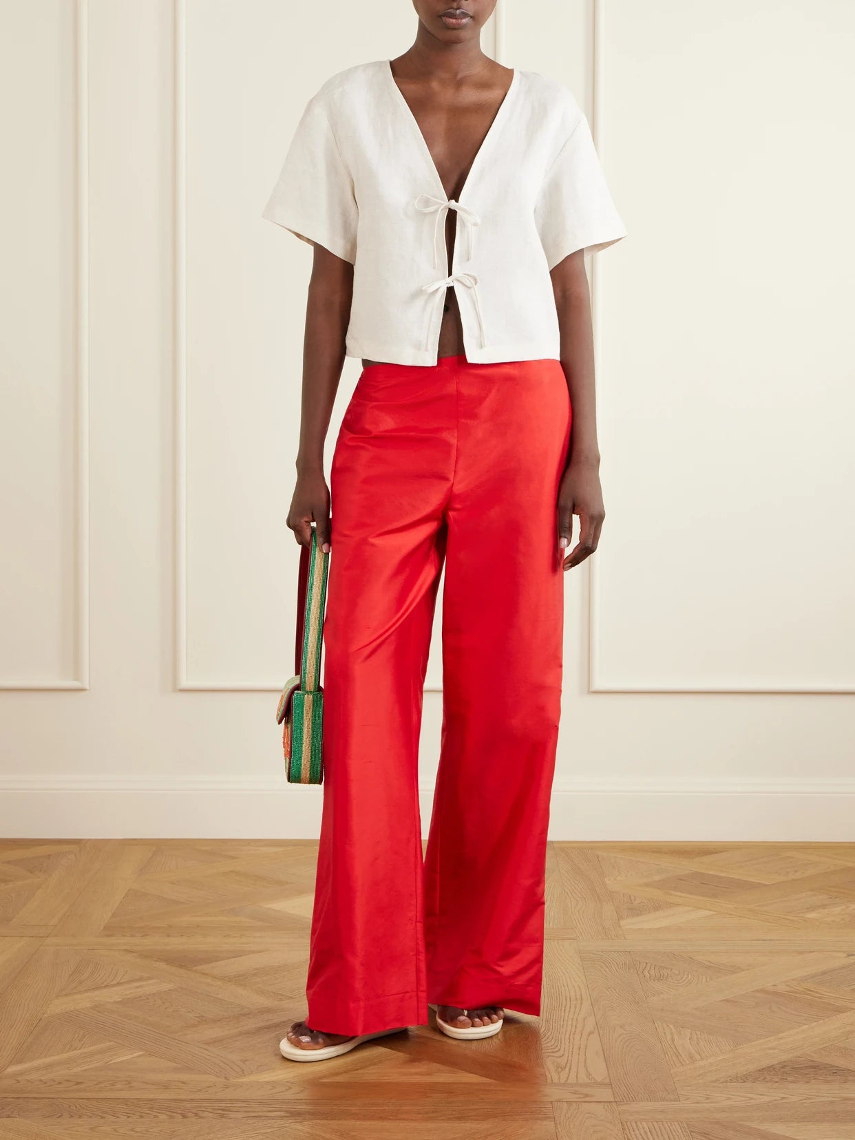Image of a model wearing Pants. Product name - Stroll Silk-dupioni Wide-leg Pants in Red colour by brand - STAUD