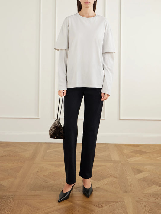Image of a model wearing Tops. Product name - Lois Layered Cotton-jersey T-shirt in Cream colour by brand - AGOLDE