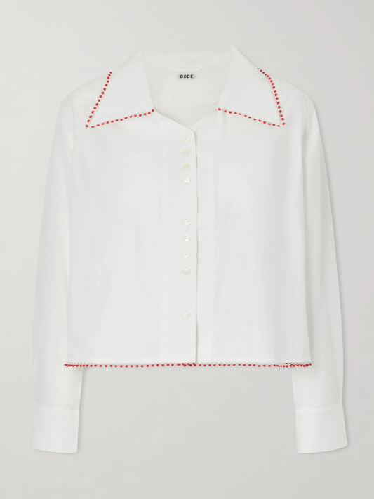 Image of a model wearing Tops. Product name - Redbud Cropped Embroidered Cotton-poplin Shirt in White colour by brand - BODE