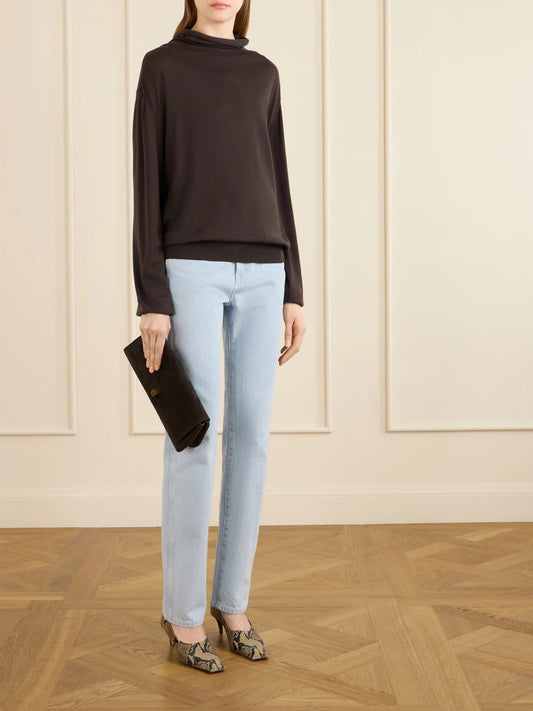 Image of a model wearing Outerwear. Product name - Annette Merino Wool Turtleneck Sweater in Dark brown colour by brand - KHAITE