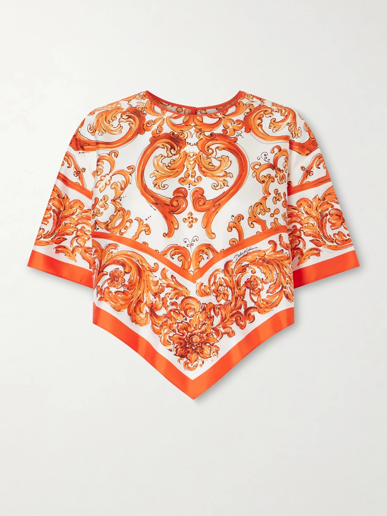 Image of a model wearing Tops. Product name - Printed Silk-twill Blouse in Orange colour by brand - Dolce & Gabbana