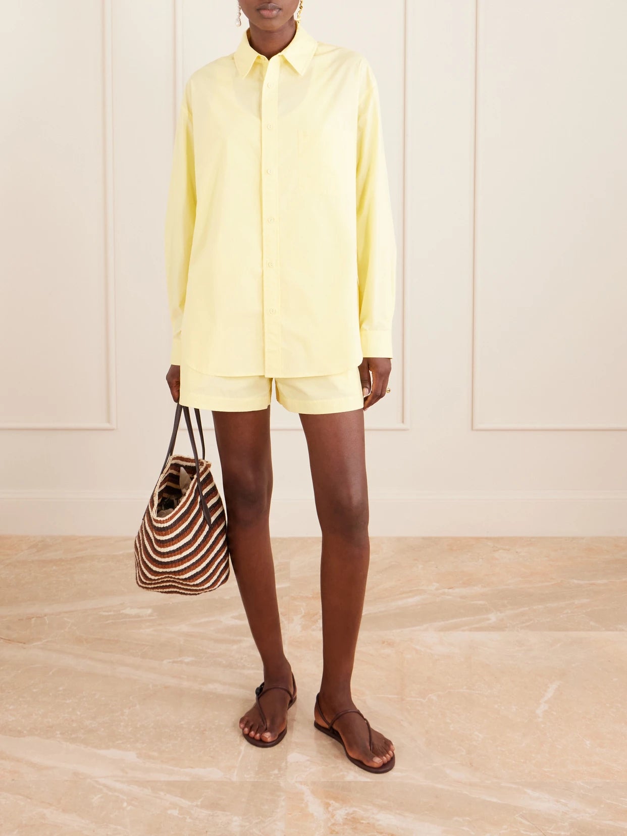 Image of a model wearing Tops. Product name - Organic Cotton-poplin Shirt in Yellow colour by brand - Matteau