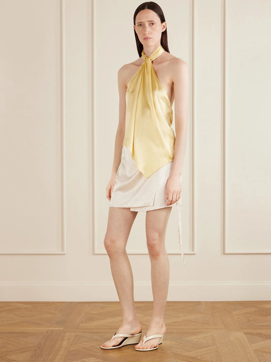 Image of a model wearing Skirts. Product name - Shejo Polka-dot Satin-jacquard Mini Skirt in White colour by brand - AFLALO
