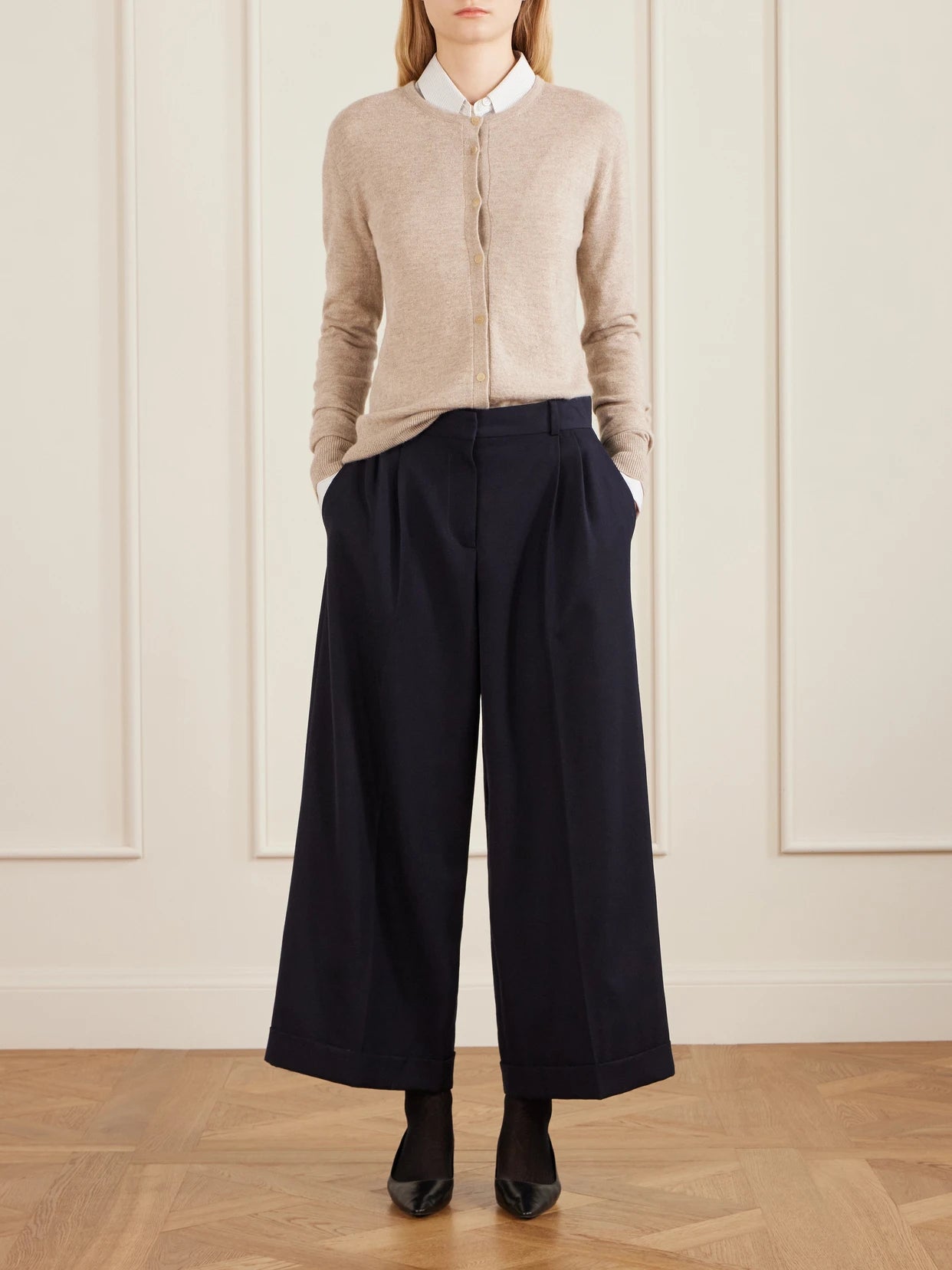 Image of a model wearing Outerwear. Product name - Noelia Cashmere Cardigan in Beige colour by brand - The Row