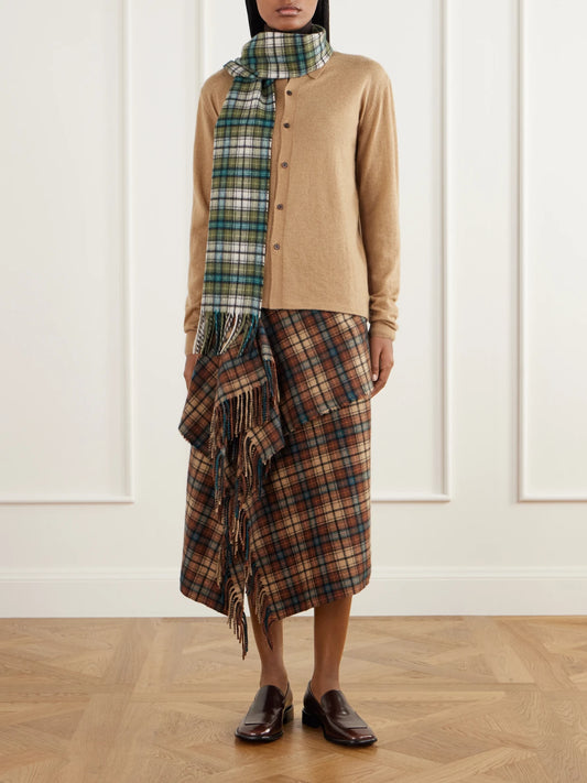 Image of a model wearing Skirts. Product name - Asymmetric Fringed Checked Cashmere Wrap Midi Skirt in Multi colour by brand - Auralee