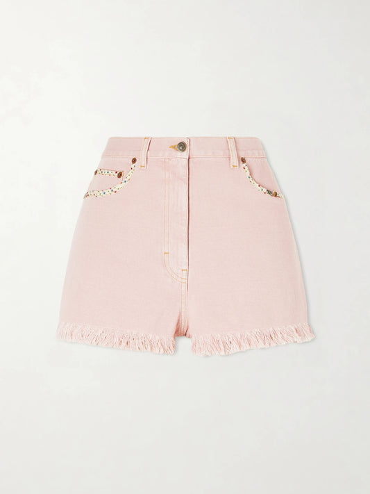 Image of a model wearing Shorts. Product name - Frayed Embellished Cotton And Linen-blend Denim Shorts in Pink colour by brand - Valentino Garavani