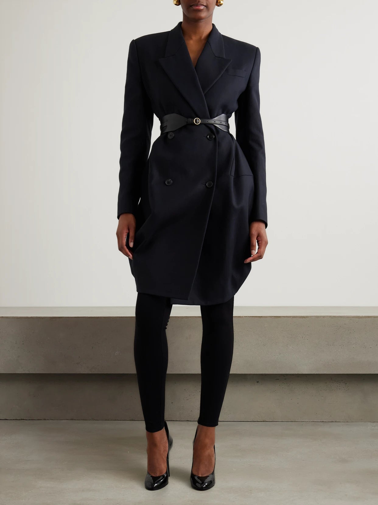 Image of a model wearing Pants. Product name - Stretch-knit Leggings in Black colour by brand - Alaïa
