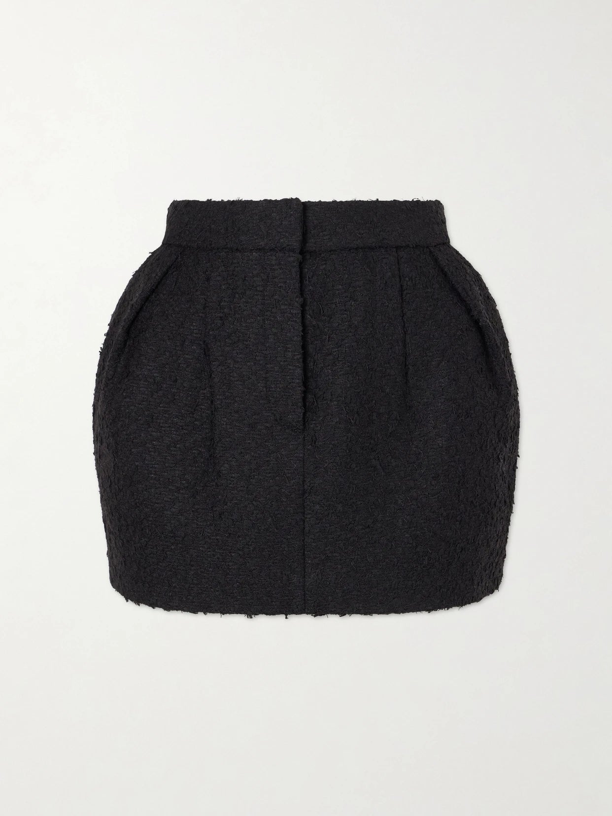 Image of a model wearing Skirts. Product name - Bouclé Mini Skirt in Black colour by brand - Magda Butrym
