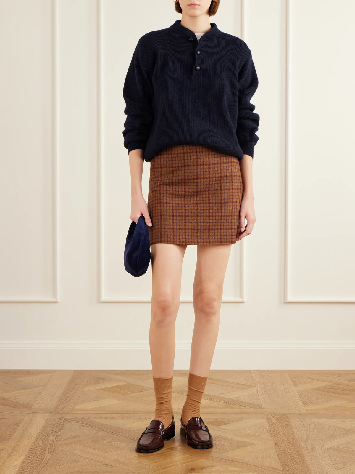 Image of a model wearing Skirts. Product name - Coci Checked Wool Mini Skirt in Brown colour by brand - BLAZÉ Milano