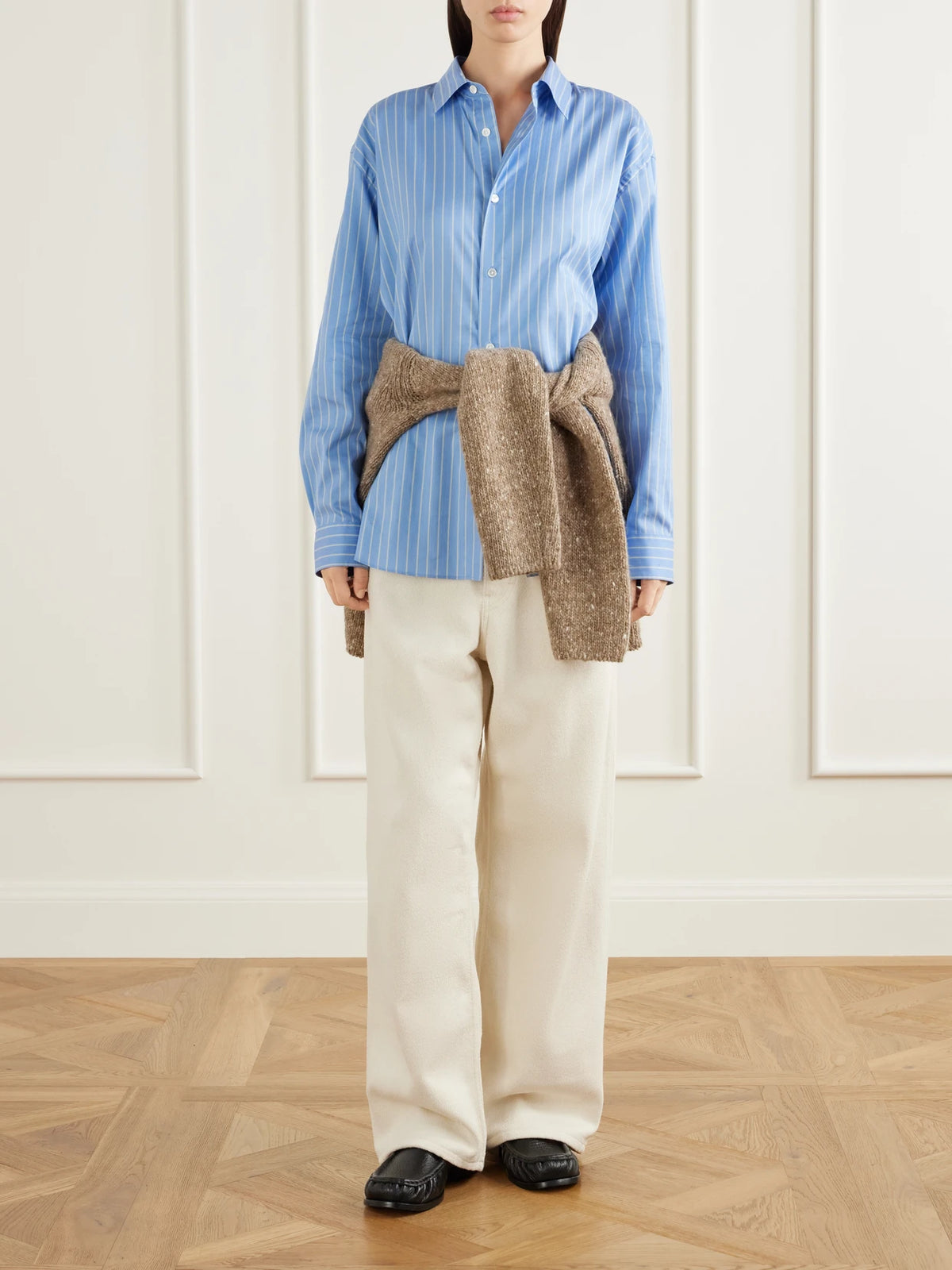 Image of a model wearing Pants. Product name - Silk Wide-leg Pants in Ivory colour by brand - Auralee