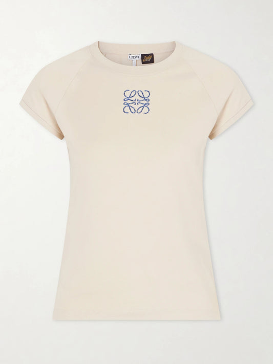 Image of a model wearing Tops. Product name - + Paula's Ibiza Anagram Embroidered Cotton T-shirt in Beige colour by brand - LOEWE