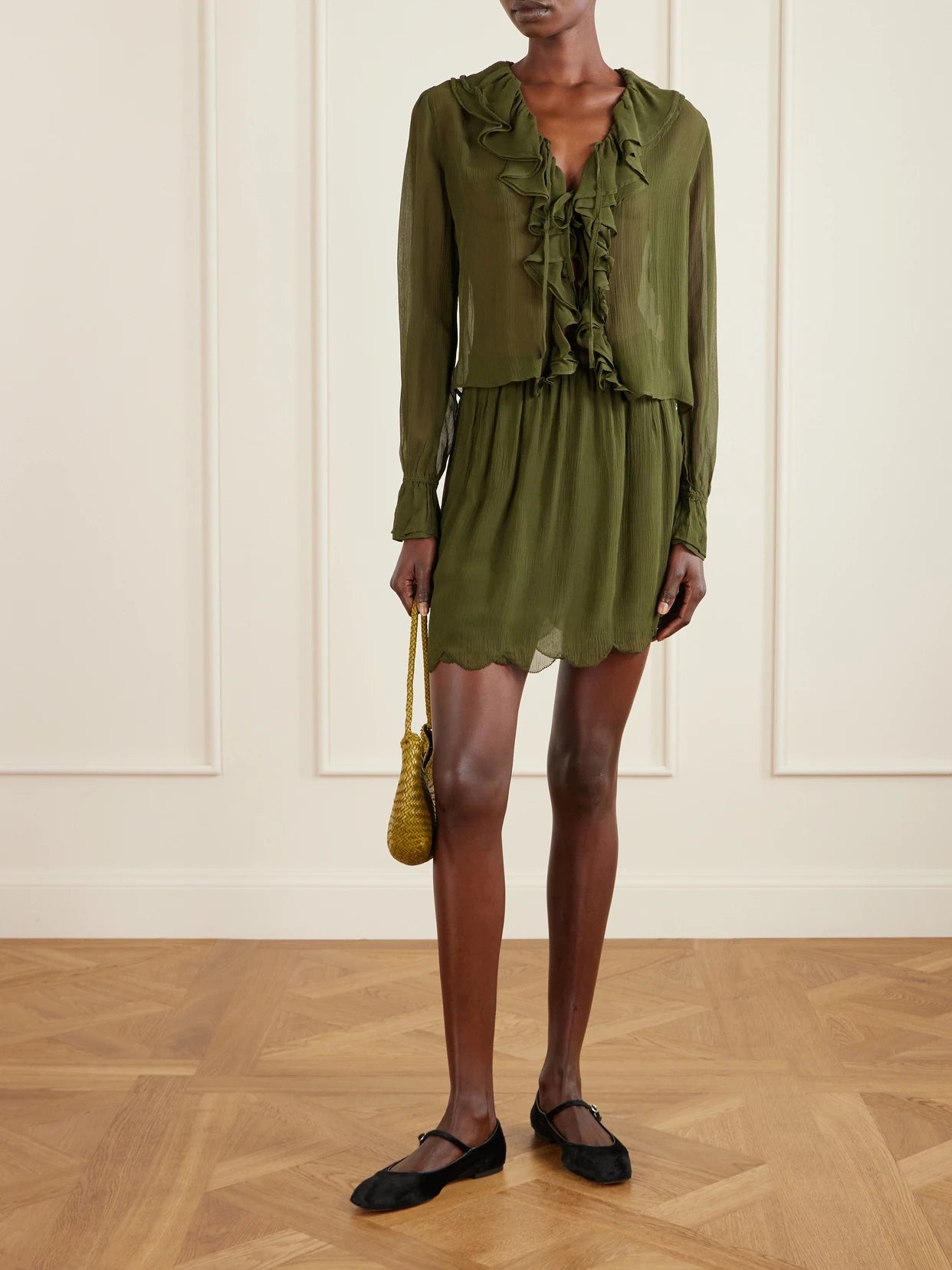 Image of a model wearing Skirts. Product name - Mab Scalloped Gathered Silk-crepon Mini Skirt in Forest green colour by brand - BODE