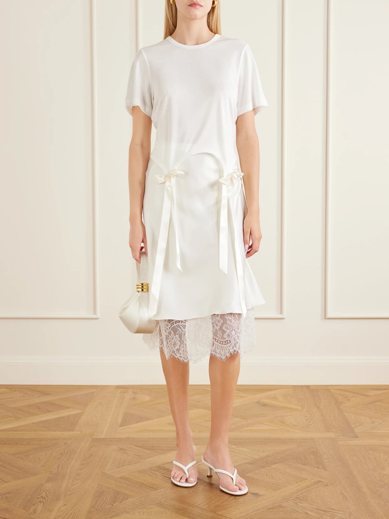 Image of a model wearing Tops. Product name - Bow-detailed Jersey T-shirt in Ivory colour by brand - Simone Rocha