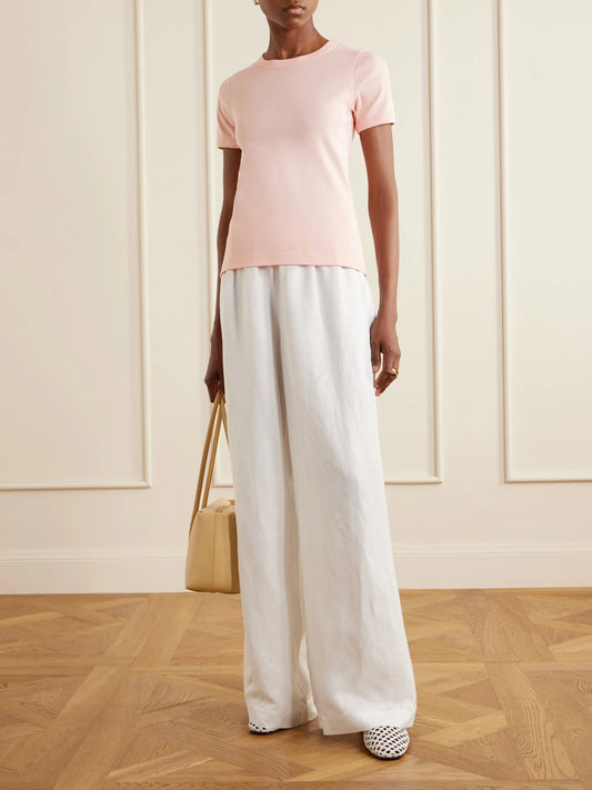 Image of a model wearing Tops. Product name - Car Organic Cotton-jersey T-shirt in Pastel pink colour by brand - FLORE FLORE