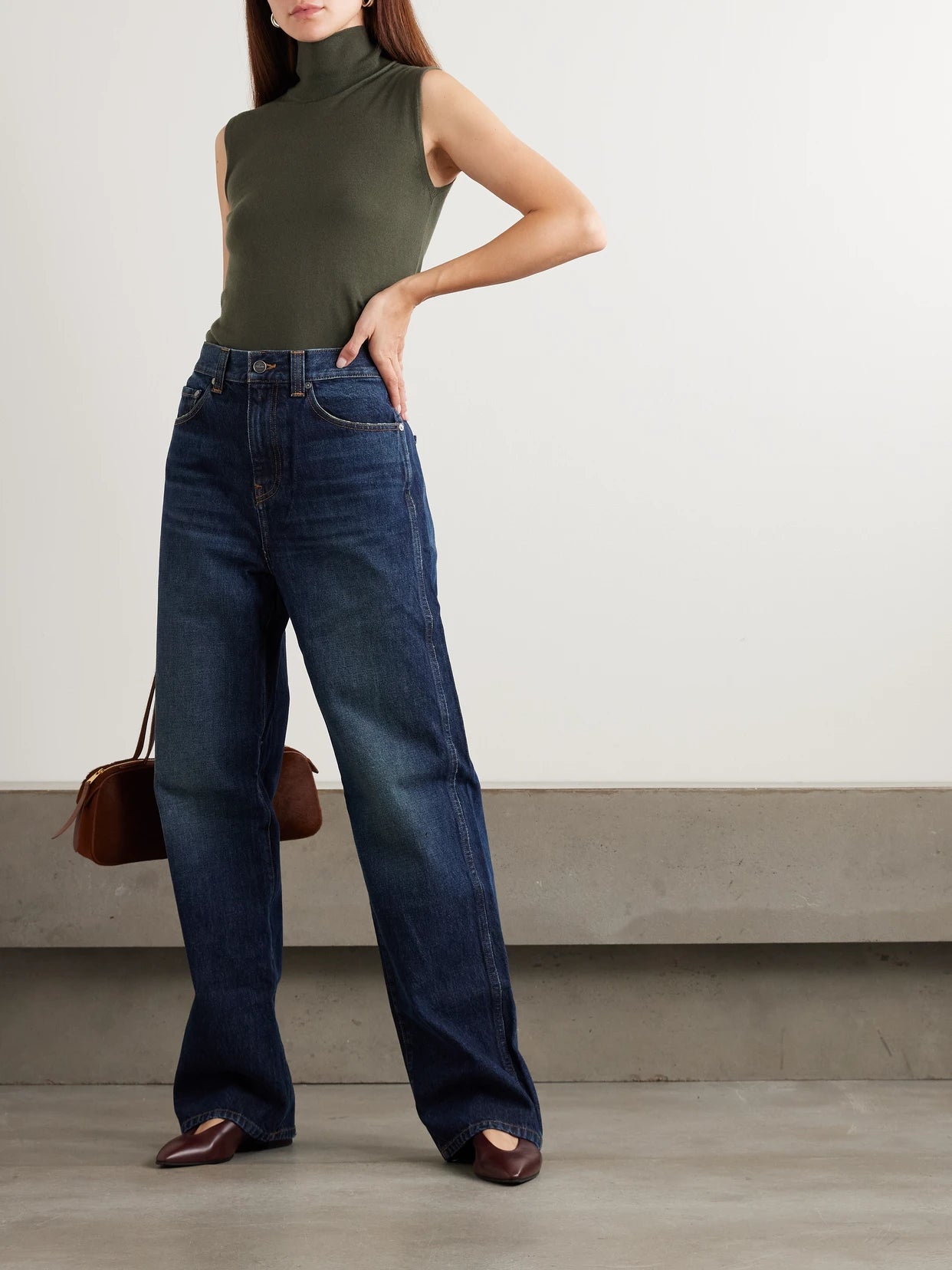 Image of a model wearing Outerwear. Product name - Piuma Cashmere Turtleneck Tank in Dark green colour by brand - Loro Piana