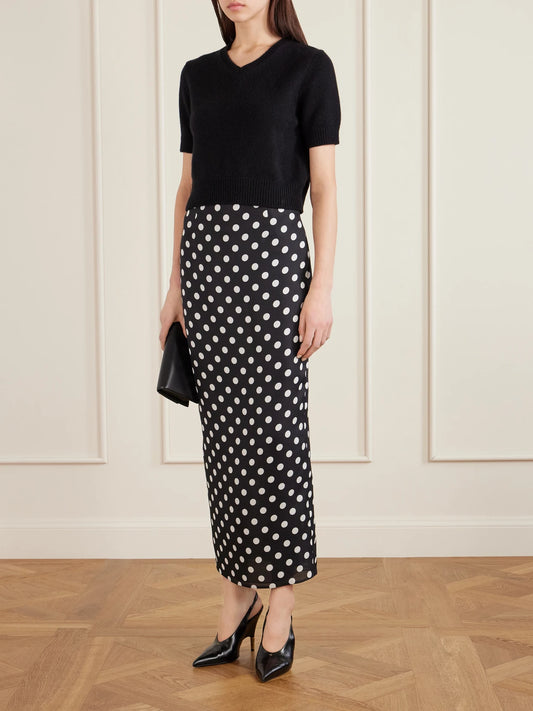 Image of a model wearing Skirts. Product name - Winton Polka-dot Silk Midi Skirt in Black colour by brand - KHAITE