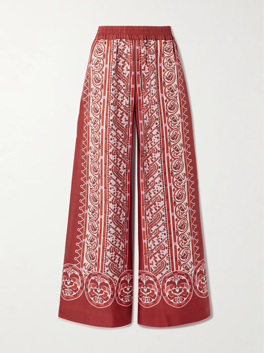 Image of a model wearing Pants. Product name - Icon Palazzo Printed Silk-twill Wide-leg Pants in Red colour by brand - La DoubleJ