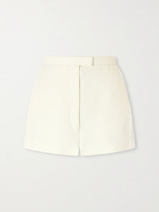 Image of a model wearing Shorts. Product name - Blane Linen Shorts in Neutral colour by brand - KHAITE