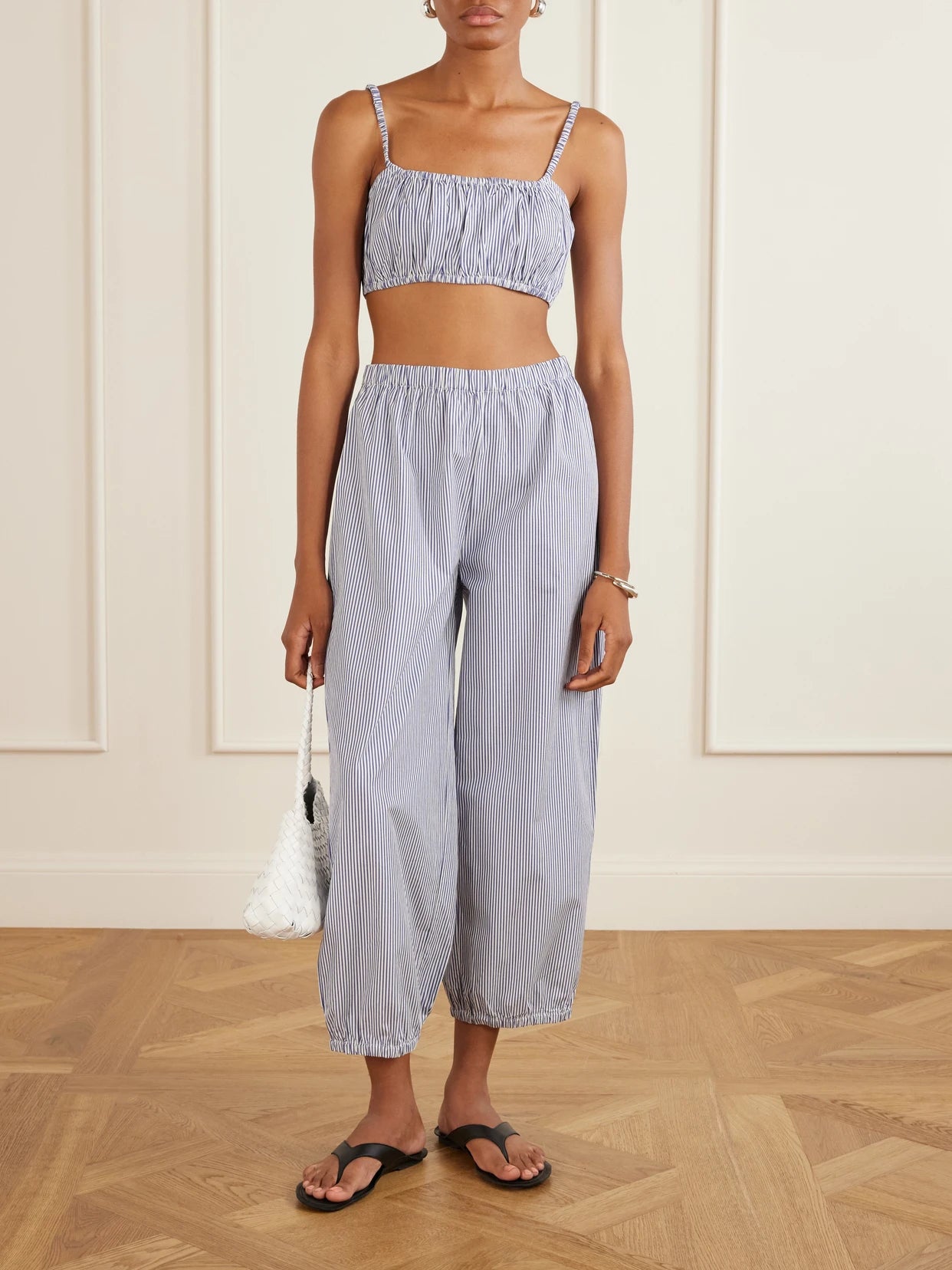Image of a model wearing Pants. Product name - Striped Cotton-poplin Balloon Pants in Navy colour by brand - Suzie Kondi