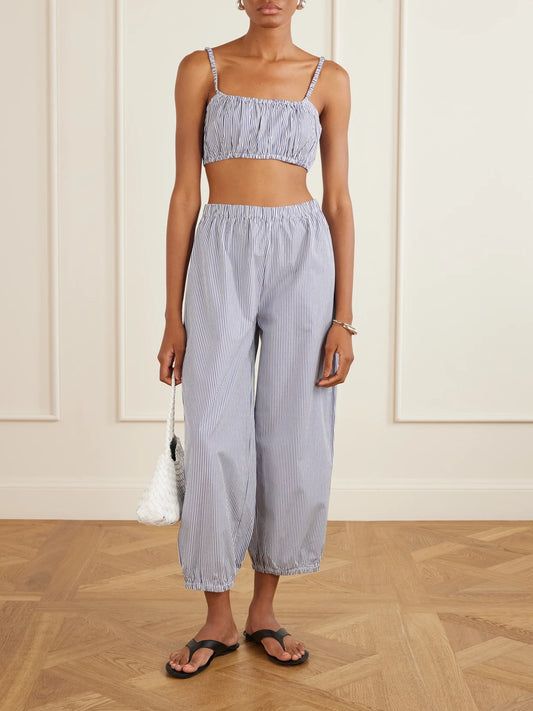 Image of a model wearing Pants. Product name - Striped Cotton-poplin Balloon Pants in Navy colour by brand - Suzie Kondi