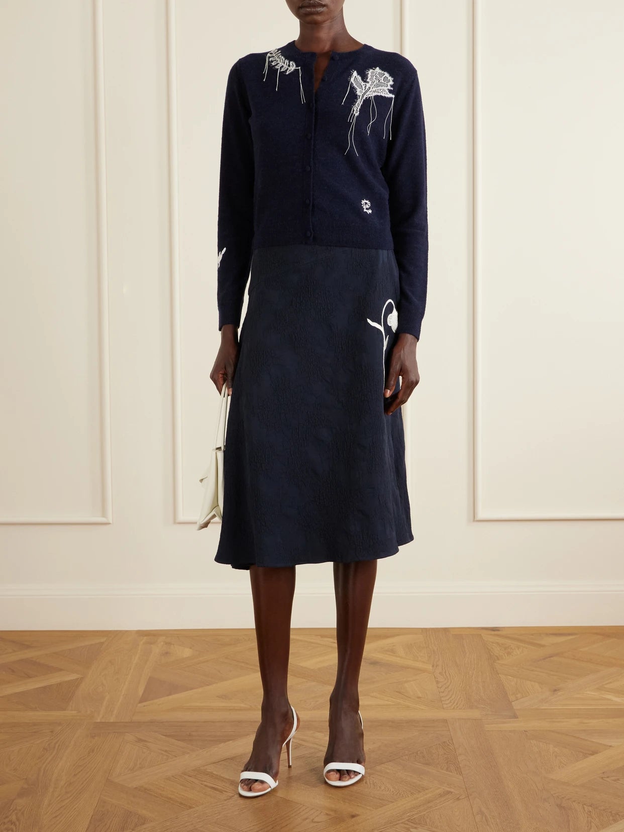 Image of a model wearing Outerwear. Product name - Embroidered Wool-blend Cardigan in Navy colour by brand - Erdem