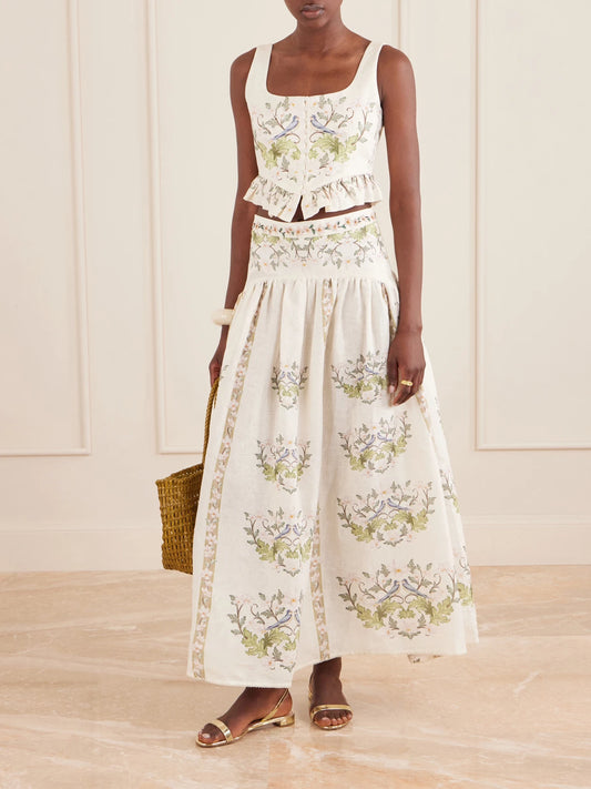 Image of a model wearing Skirts. Product name - Curua Anhelo Floral Linen Midi Skirt in Cream colour by brand - Agua by Agua Bendita