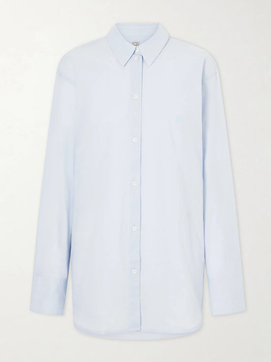 Image of a model wearing Tops. Product name - Cotton And Linen-blend Shirt in Light blue colour by brand - TOTEME