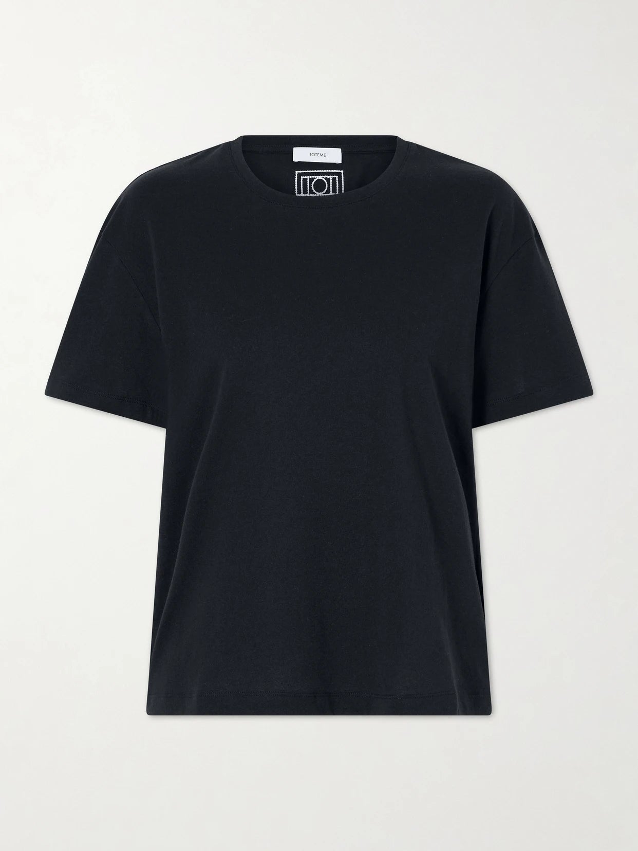 Image of a model wearing Tops. Product name - Logo-embroidered Organic Cotton T-shirt in Black colour by brand - TOTEME