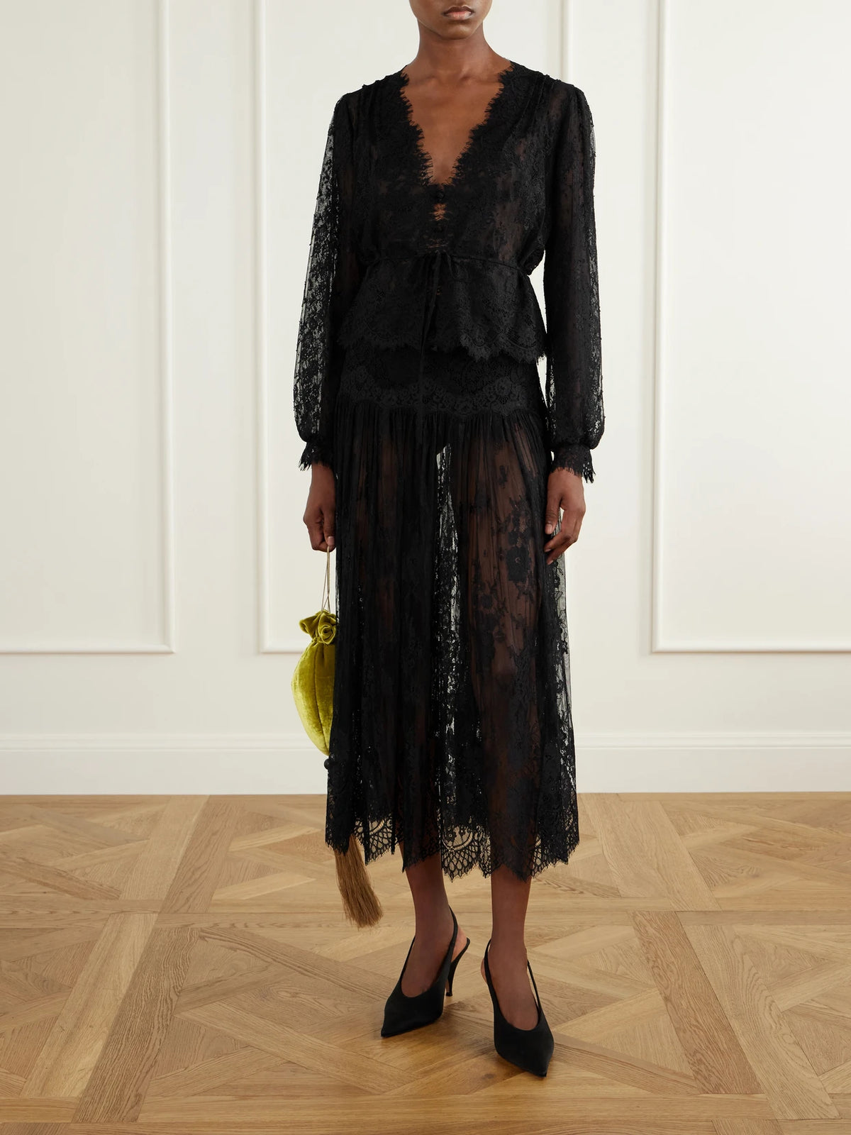 Image of a model wearing Skirts. Product name - Giorgine Scalloped Lace Midi Skirt in Black colour by brand - DÔEN