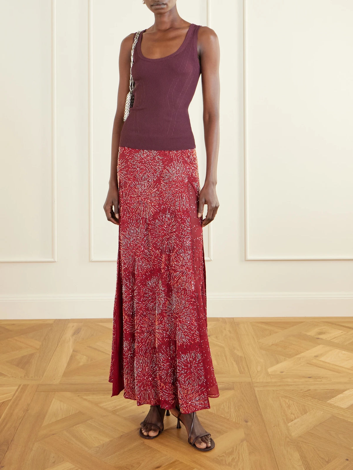 Image of a model wearing Skirts. Product name - Embellished Crepe Maxi Skirt in Red colour by brand - RABANNE