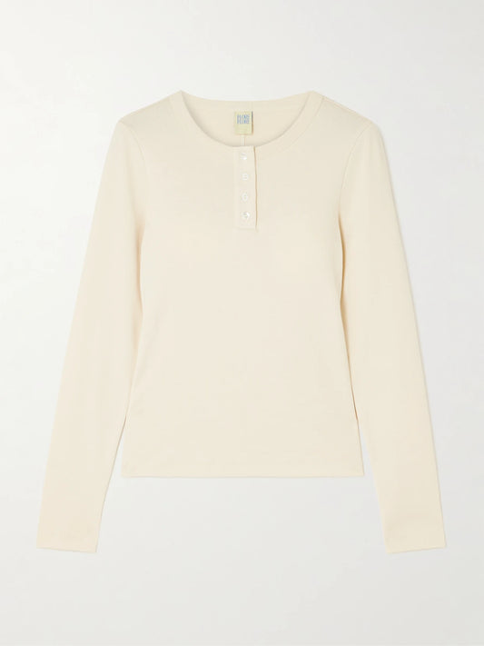Image of a model wearing Tops. Product name - Jess Ribbed Organic Cotton-jersey Henley Top in Off-white colour by brand - FLORE FLORE