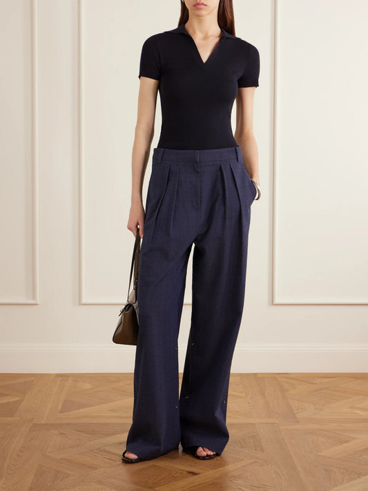 Image of a model wearing Pants. Product name - Stella Pleated Checked Wool And Cotton-blend Wide-leg Pants in Navy colour by brand - Tibi