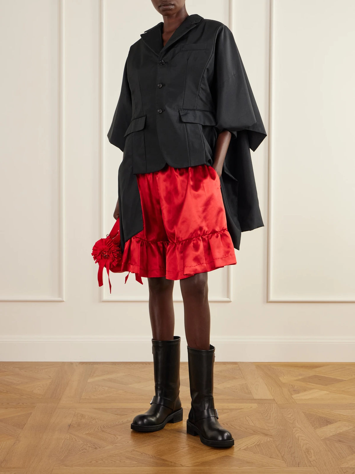Image of a model wearing Shorts. Product name - Ruffled Satin Shorts in Black colour by brand - Comme des Garçons GIRL