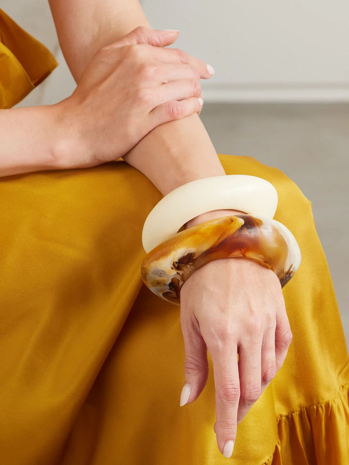 Image of Bracelets. Product name - Rock Set Of Two Resin Bangles in Cream colour by brand - Dinosaur Designs