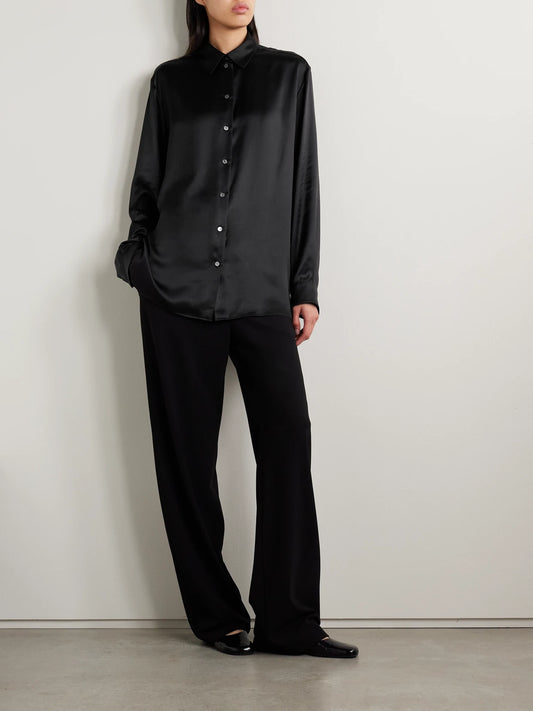 Image of a model wearing Tops. Product name - Sisilia Oversized Silk-satin Shirt in Black colour by brand - The Row